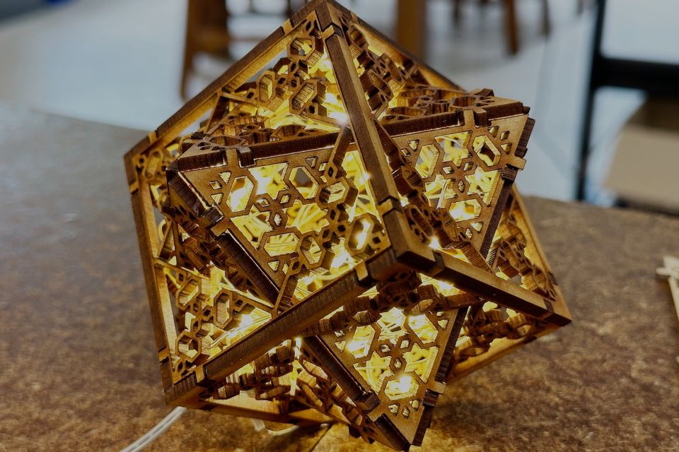 An intricate laser-cut timber polyhedron